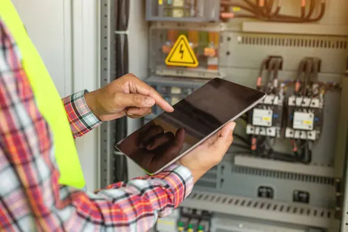 Commercial electrician in Leicestershire inspecting an industrial control panel