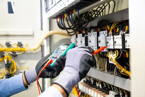 Electrician in Hinckley testing a distribution board before an EV charger install