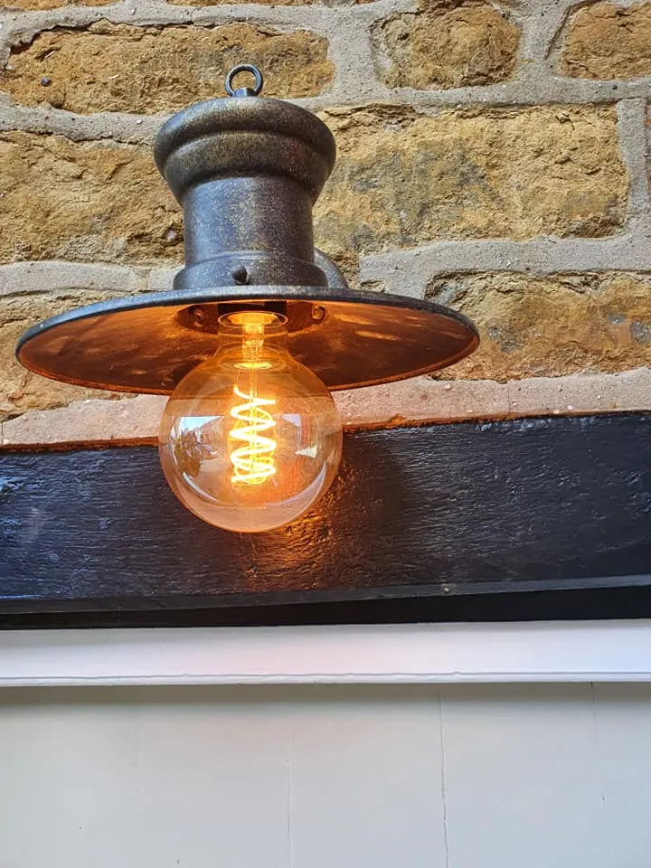 Period-style outdoor lantern on a stone wall